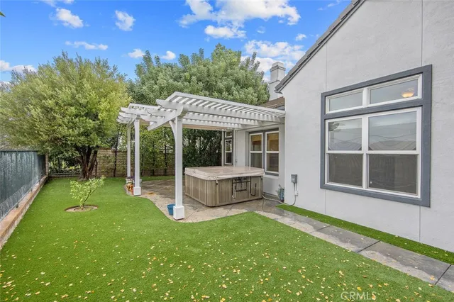 a view of a house with a yard and sitting area