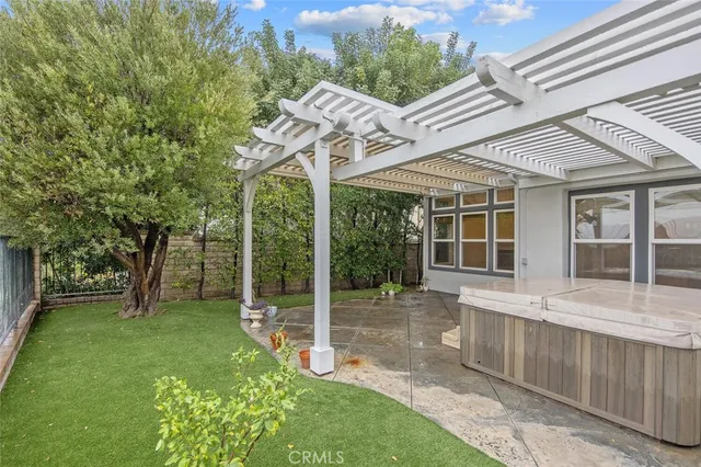 a view of a house with a backyard and a patio