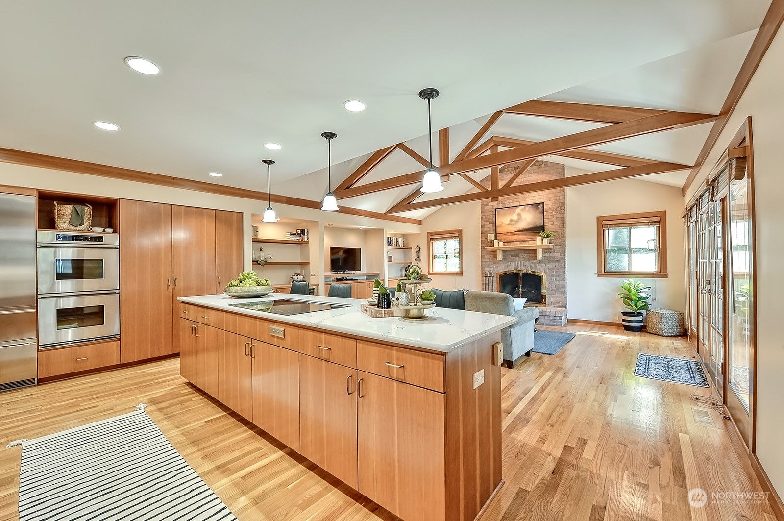 608 Clark Road Bellingham, WA 98225 - Photo 14 of 40 a large kitchen with kitchen island a stove a sink dishwasher and a fireplace with wooden floor