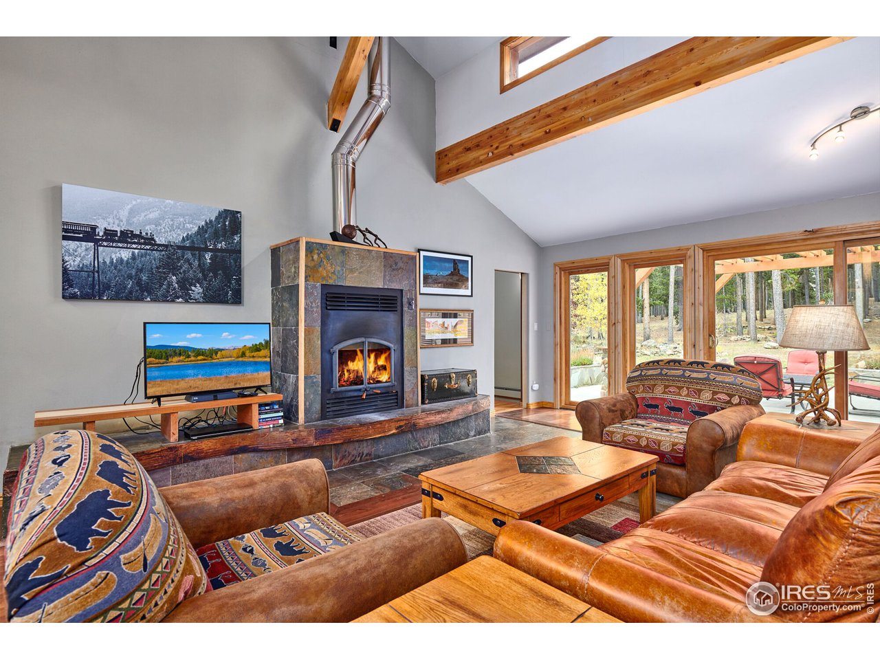 Open Living room with Stone Wood burning fireplace
