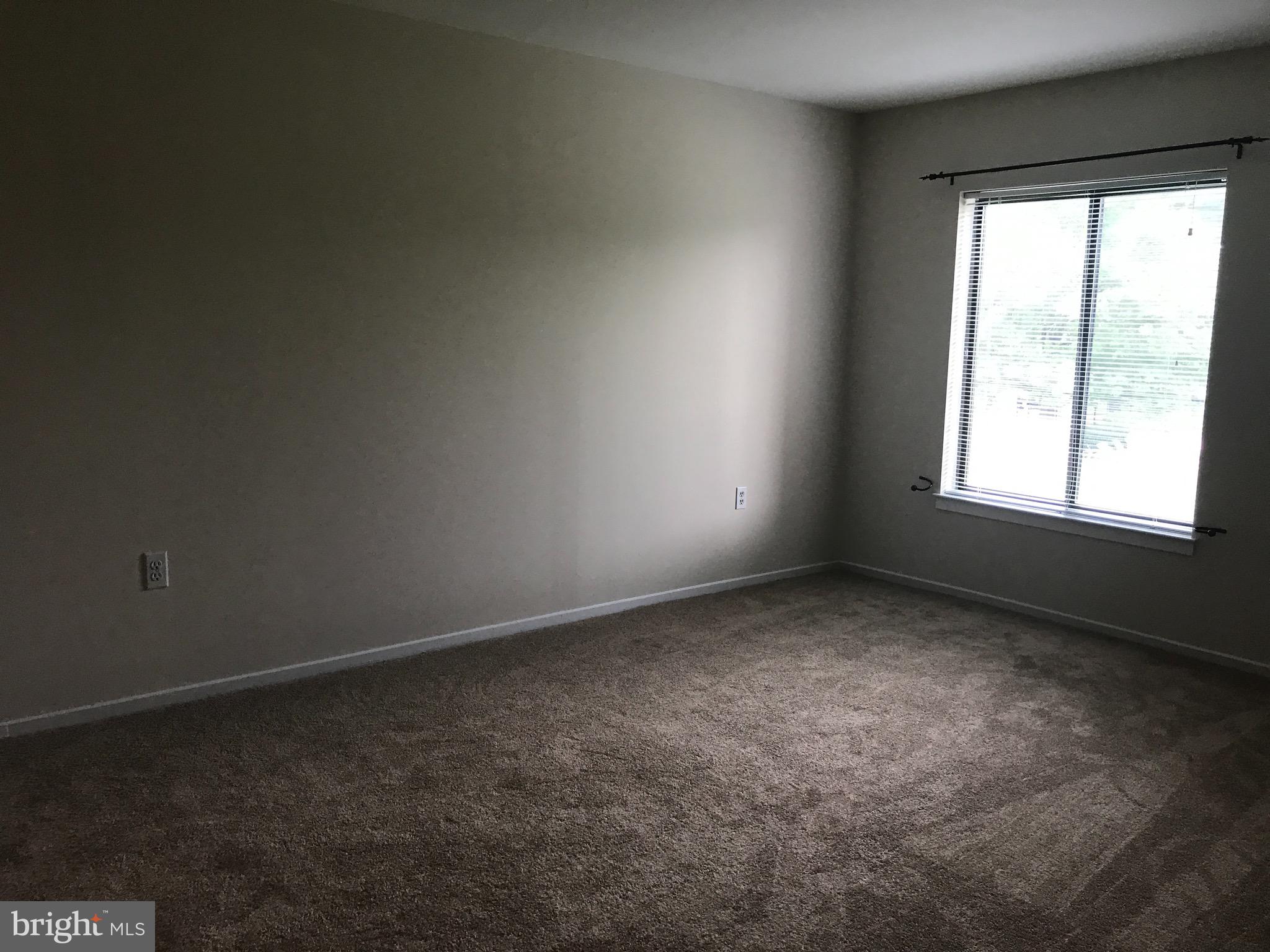 10028 Stedwick Road, Unit 202 Montgomery Village, MD 20886 - Photo 13 of 15 an empty room with a window