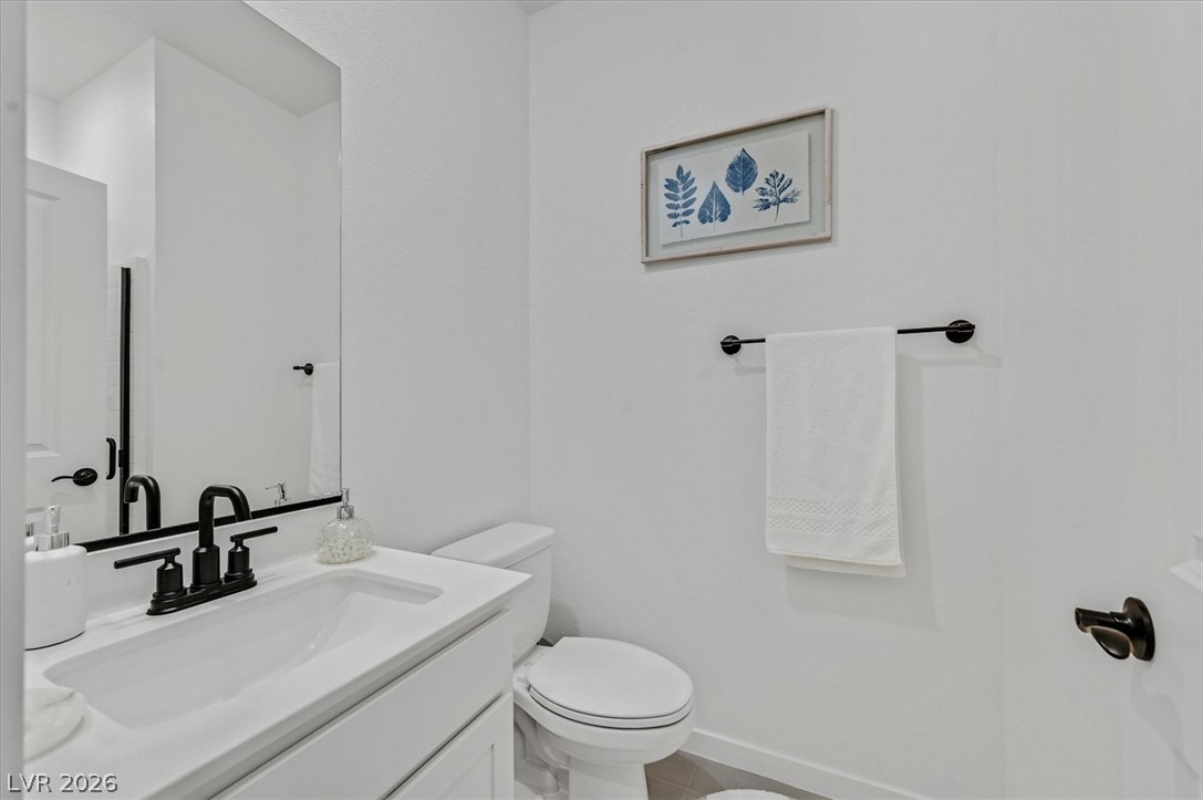 2933 Little Current Road North Las Vegas, NV 89086 - Photo 14 of 35 A pristine powder room offers a sleek vanity with modern fixtures and a practical layout.