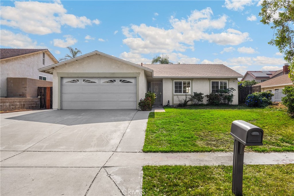 6859 Mango Street Rancho Cucamonga, CA 91701 - Photo 1 of 1 a front view of a house with a yard and a garage