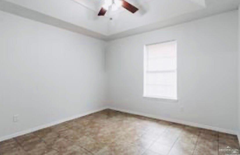 241 East 19th Street, Unit 3 Weslaco, TX 78596 - Photo 5 of 10 an empty room with a window and a fan