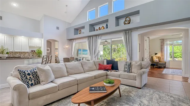 a living room with patio furniture and a floor to ceiling window