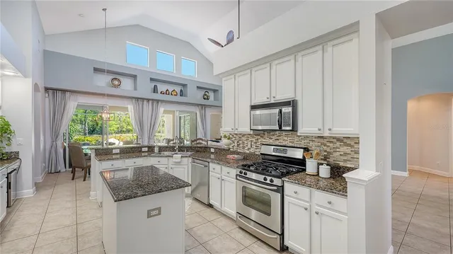 a kitchen with stainless steel appliances granite countertop a refrigerator and a stove