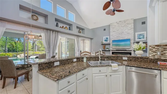 a bathroom with a granite countertop toilet a sink and a mirror
