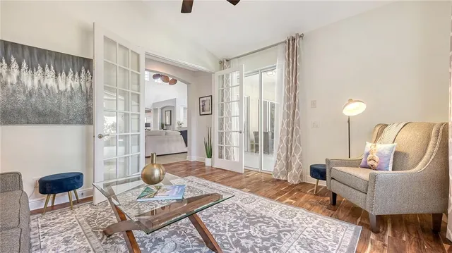 a view of a lake with a yard and potted plants