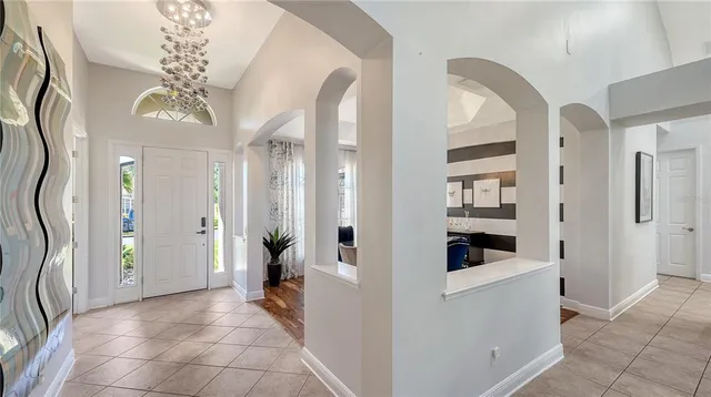 a living room with furniture and a book shelf