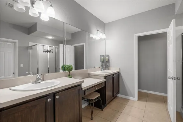 a bathroom with a sink double vanity and a mirror