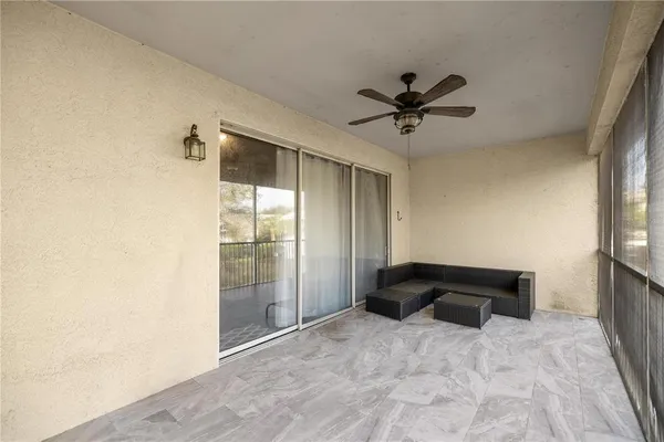 a bedroom with a bed and a ceiling fan