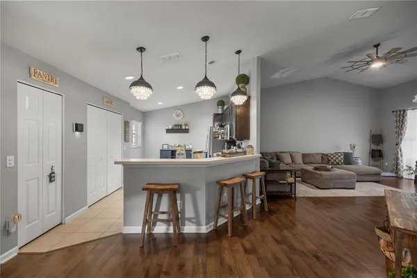 a living room with furniture a wooden floor and a chandelier