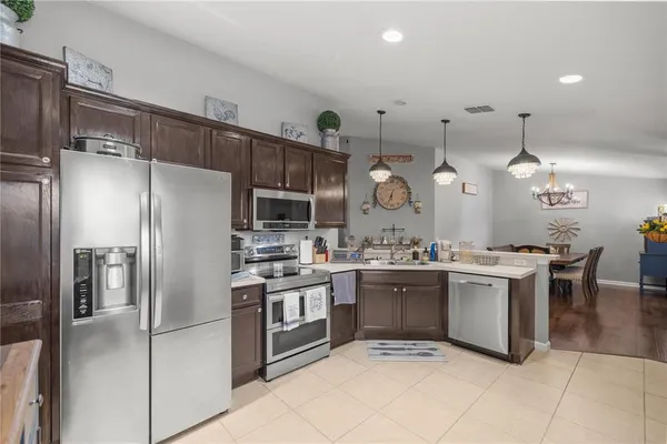 a kitchen with lots of counter top space and stainless steel appliances