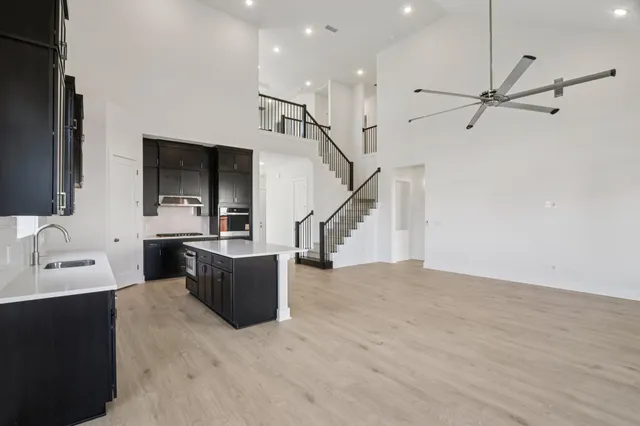 a view of a living room with furniture and a kitchen view