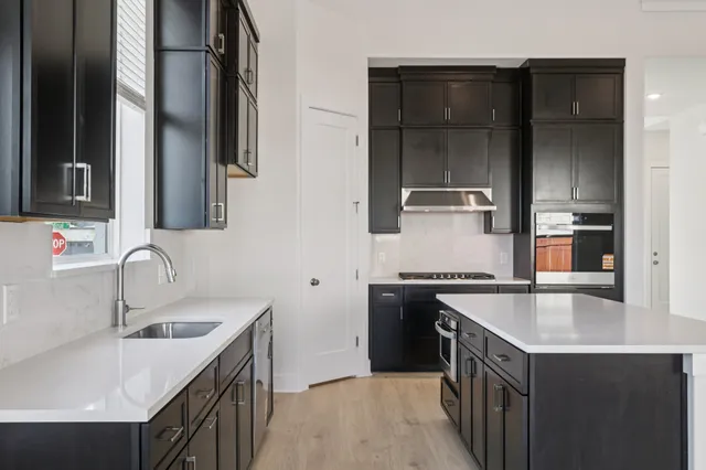 a kitchen with granite countertop a sink and a window
