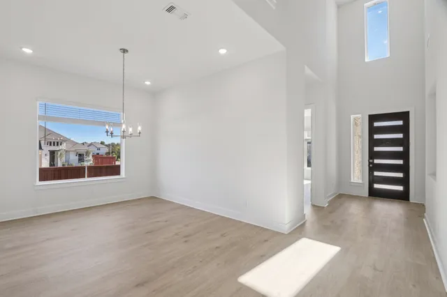 a view of room with balcony and wooden floor