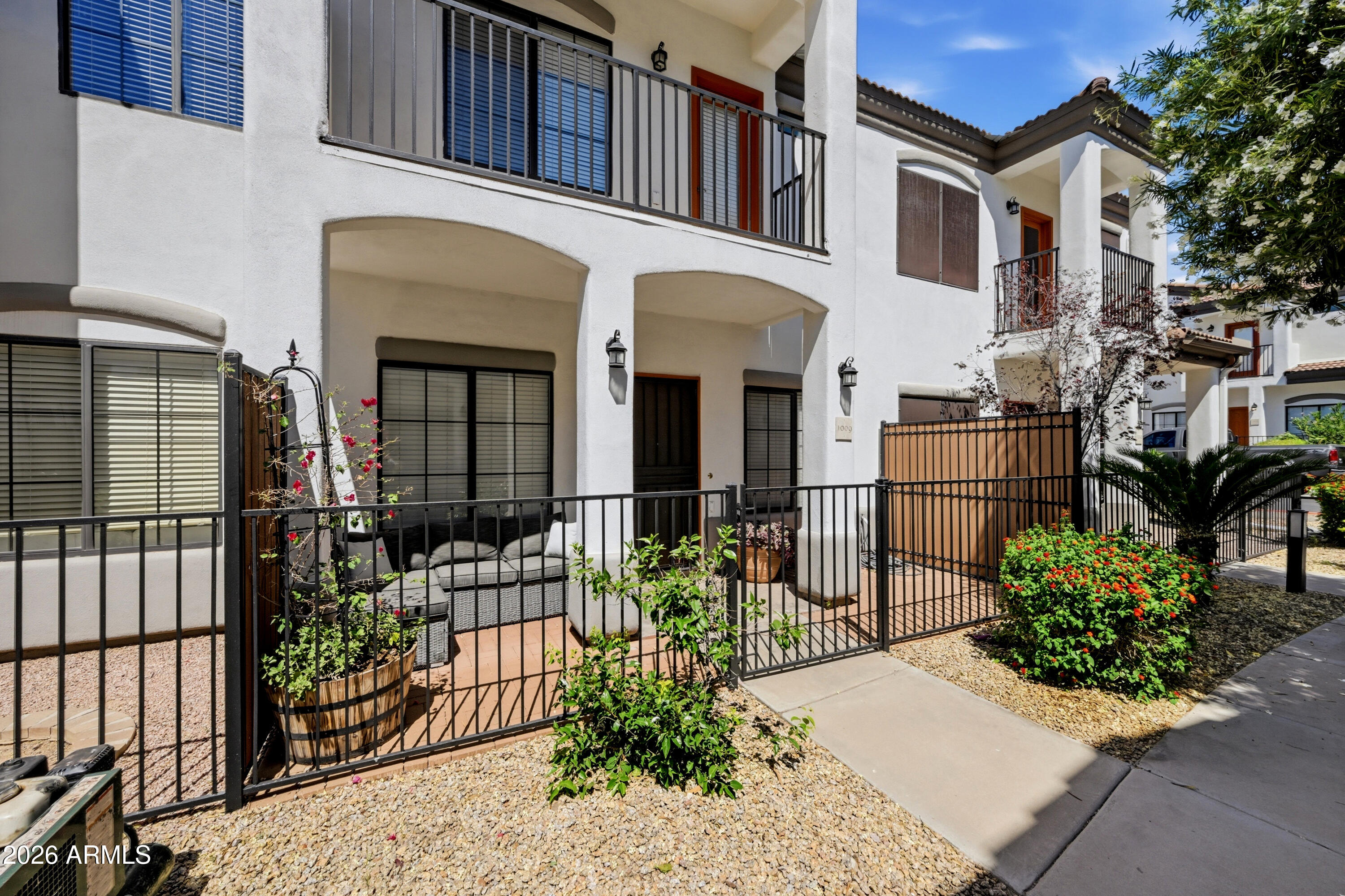 3150 East Beardsley Road, Unit 1009 Phoenix, AZ 85050 - Photo 3 of 31 a view of a house with large windows and potted plants