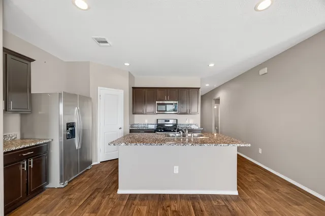 a kitchen with a stove a sink and a refrigerator