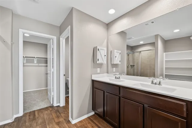 a bathroom with a glass shower door