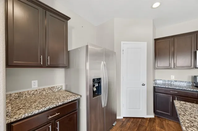 a kitchen with stainless steel appliances granite countertop a stove and a microwave