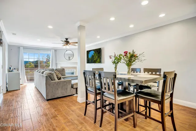 a view of a dining room with furniture and wooden floor