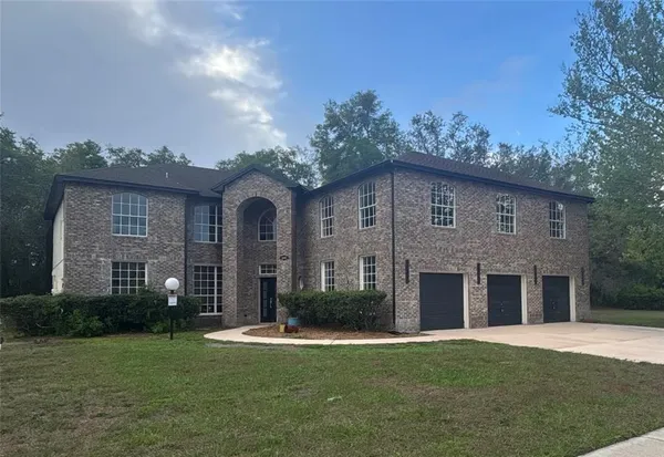 a front view of a house with a garden and plants