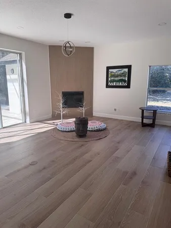 a view of a hallway with wooden floor and stairs