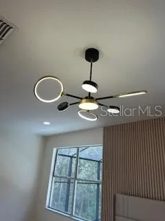 a view of a livingroom with furniture wooden floor and chandelier