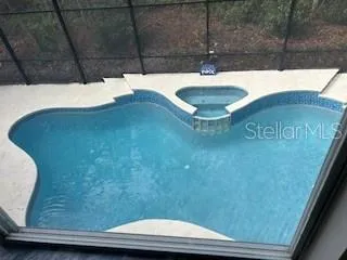 a kitchen with stainless steel appliances a dining table chairs stove and refrigerator