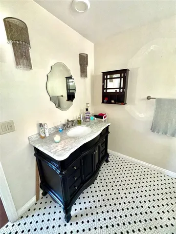 a bathroom with a sink vanity and a mirror