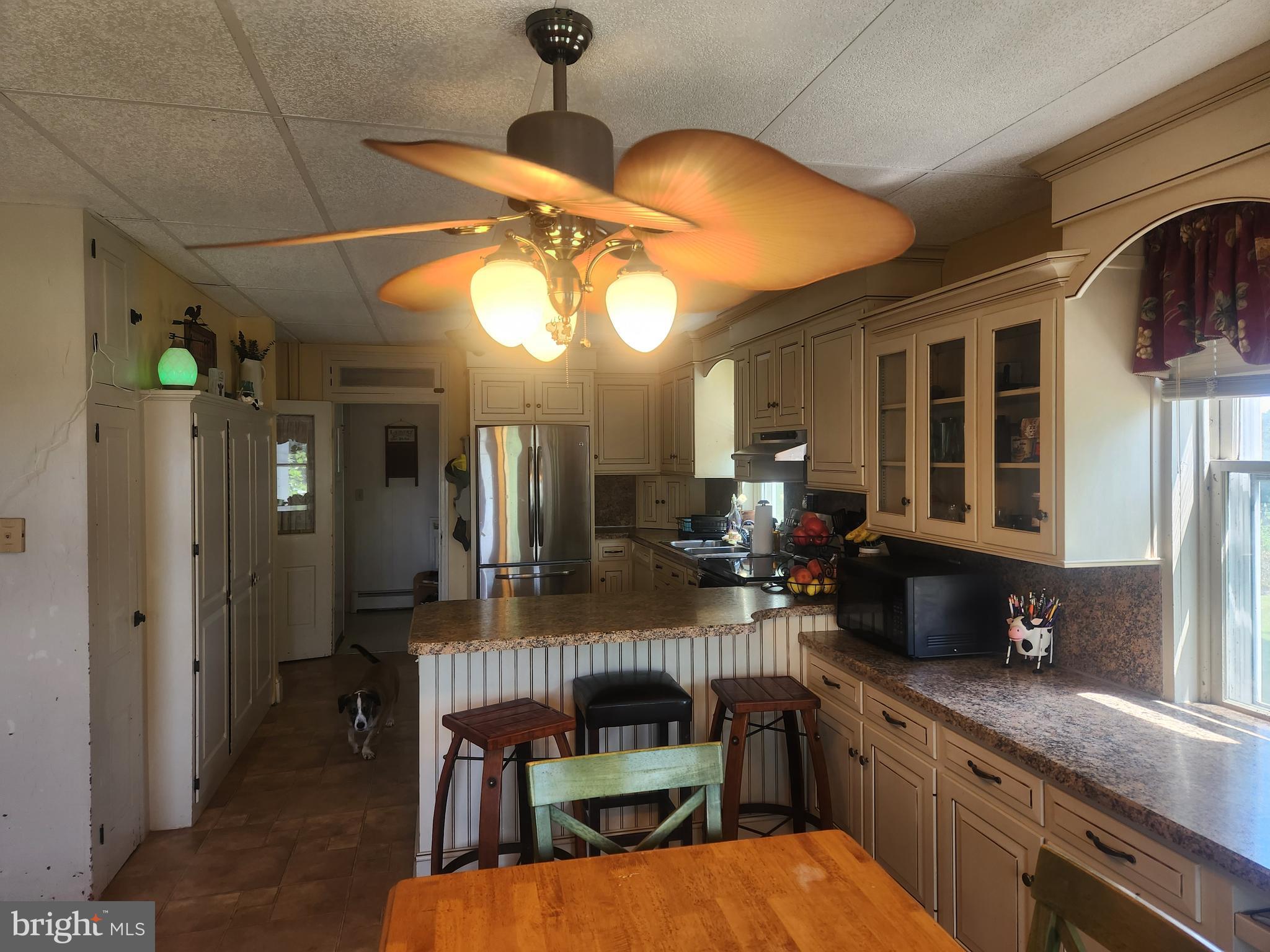 2344 Back Run Road Manheim, PA 17545 - Photo 6 of 85 a kitchen with stainless steel appliances granite countertop a refrigerator a sink dishwasher a dining table and chairs with wooden floor