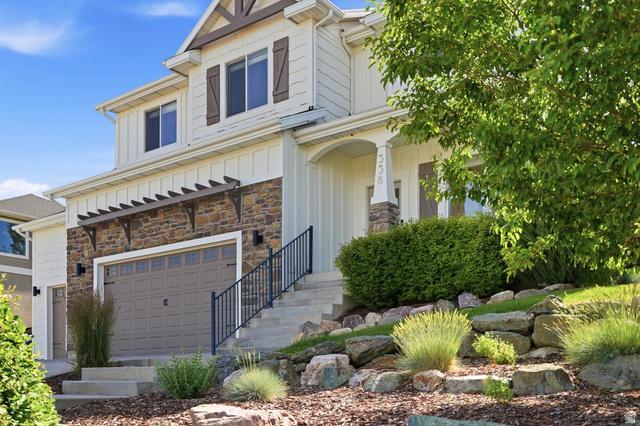 338 Windy Rdg Drive Smithfield, UT 84335 - Photo 5 of 63 Two-story residence featuring light-colored siding, a stone facade, and dark brown window shutters