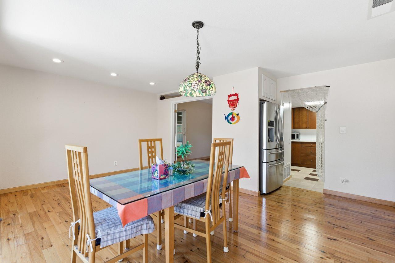 5561 Roundtree Common Fremont, CA 94538 - Photo 2 of 29 a view of a dining room with furniture wooden floor and a chandelier