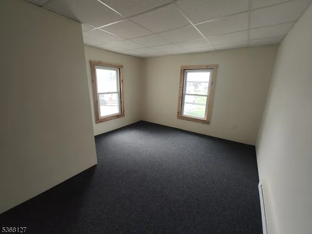 an empty room with a empty space and windows