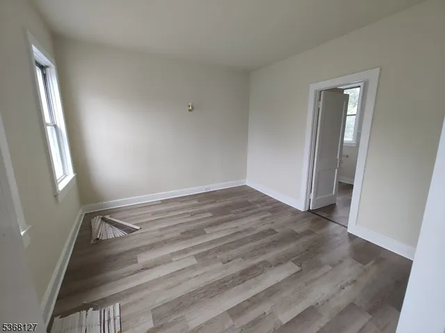 a view of room with window and wooden floor