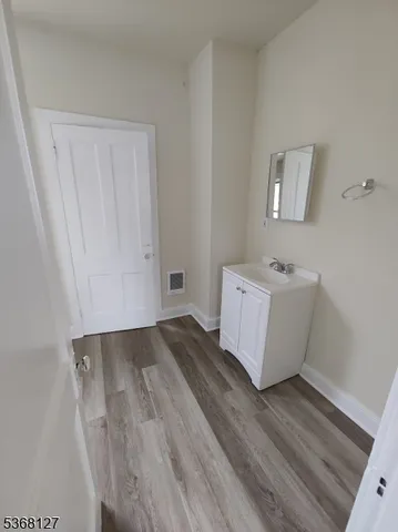 a view of a room with wooden floor and cabinet