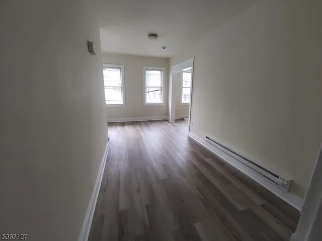 a view of wooden floor and windows in a room