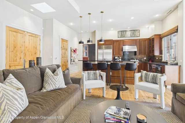 a view of a dining room with furniture a chandelier and wooden floor