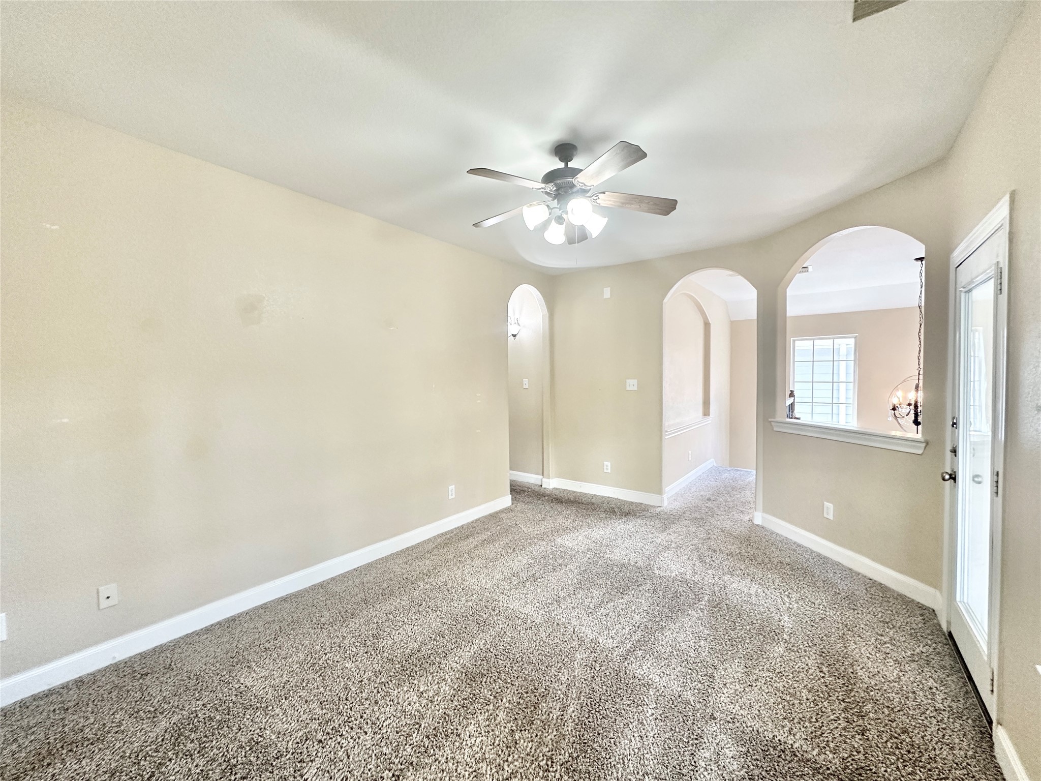 43 Panterra Way Spring, TX 77382 - Photo 11 of 17 an empty room with chandelier fan and windows