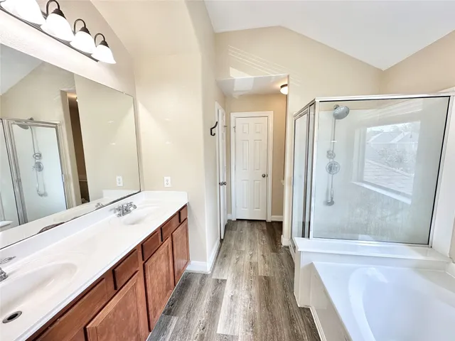a spacious bathroom with a tub shower vanity and a sink