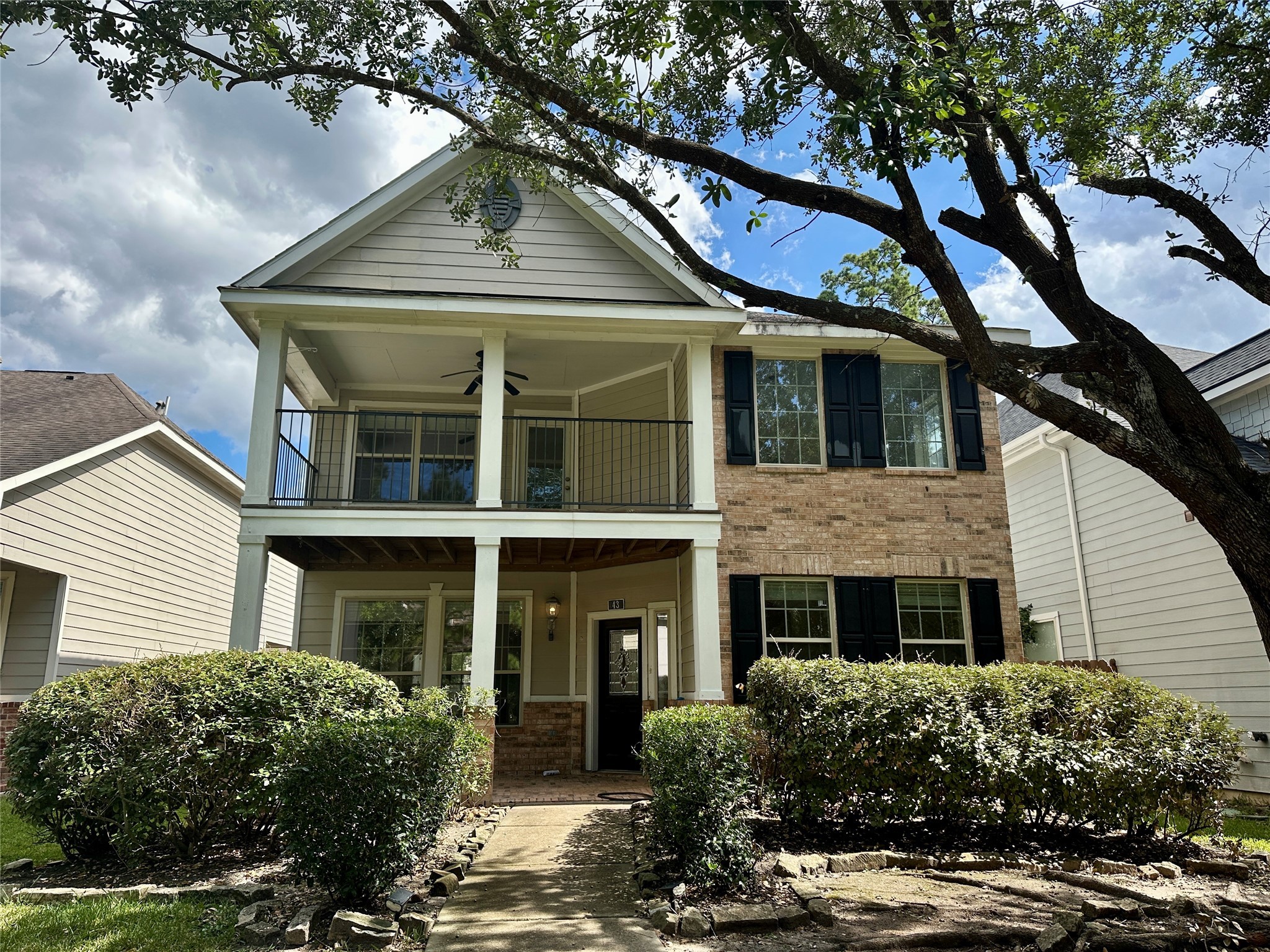 43 Panterra Way Spring, TX 77382 - Photo 2 of 17 a front view of a house with a yard garage and outdoor seating