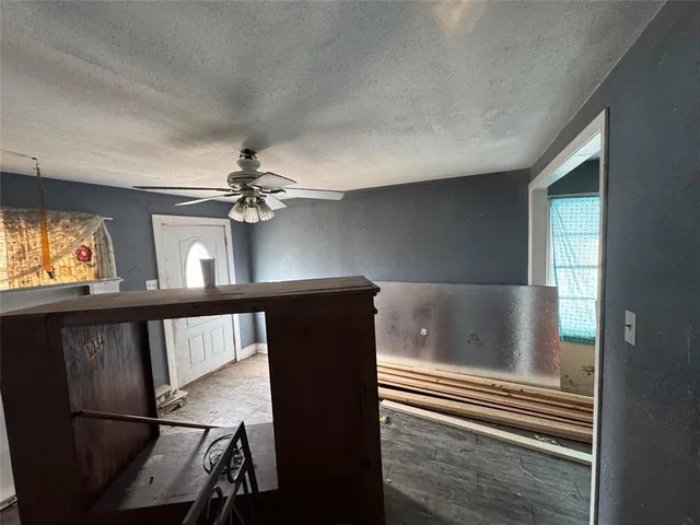 a view of a hallway with furniture and a window