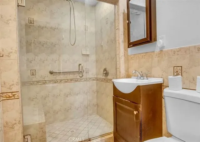 a bathroom with a sink shower and a mirror