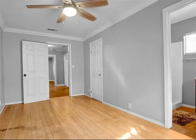 a view of a bedroom with a bed and a chandelier fan