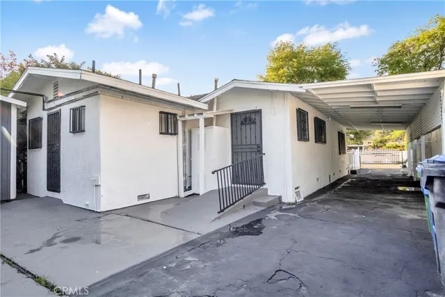 a view of a white house with a outdoor space
