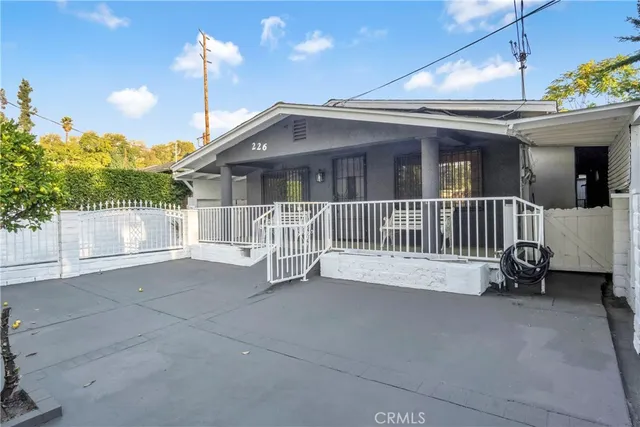a view of an house with porch and a floor to ceiling window