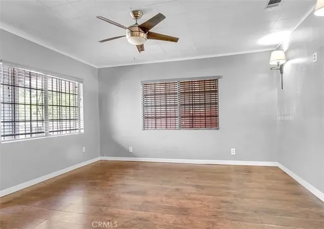 wooden floor in an empty room with a window