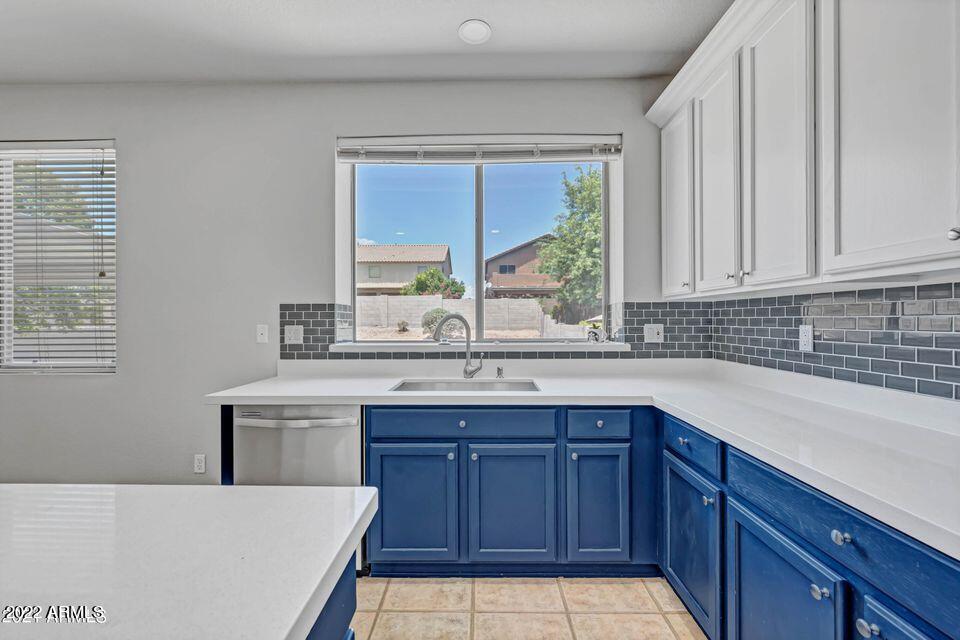 6410 West Hackamore Drive Phoenix, AZ 85083 - Photo 20 of 50 a kitchen with a sink a window and cabinets