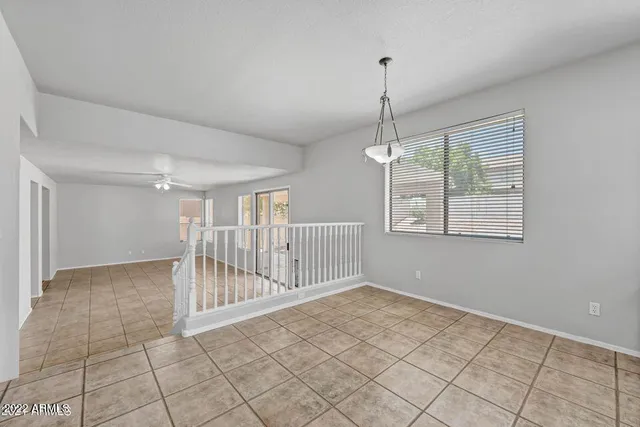 a kitchen with stainless steel appliances granite countertop a stove a sink dishwasher a refrigerator and white cabinets with wooden floor