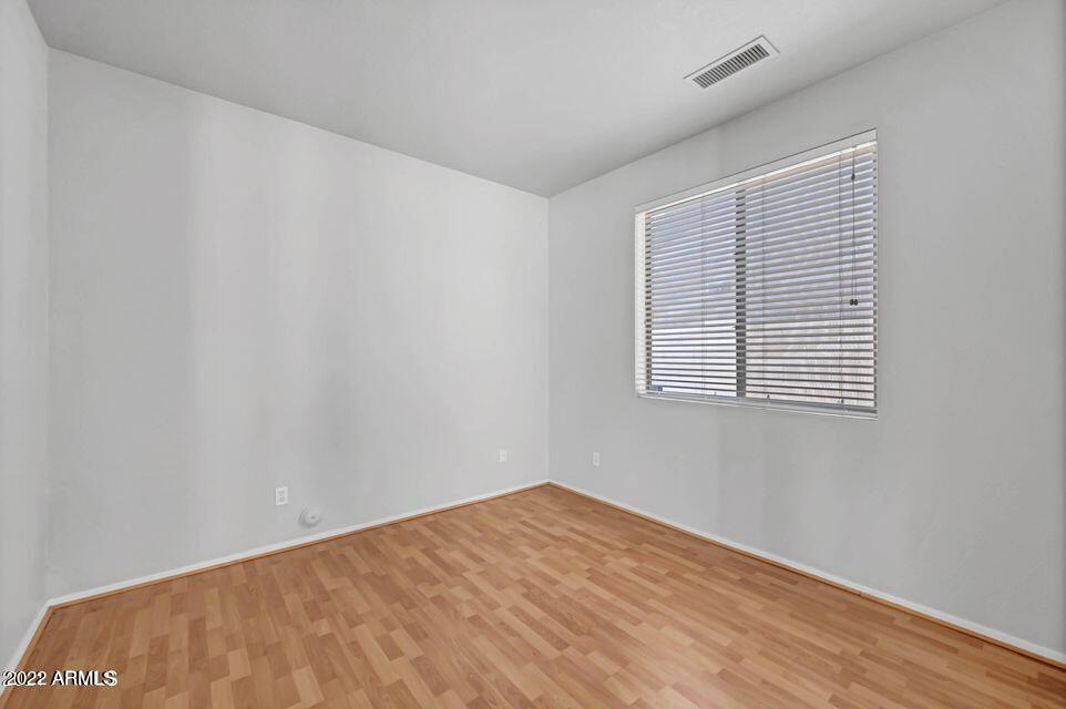6410 West Hackamore Drive Phoenix, AZ 85083 - Photo 28 of 50 a view of an empty room with wooden floor and a window